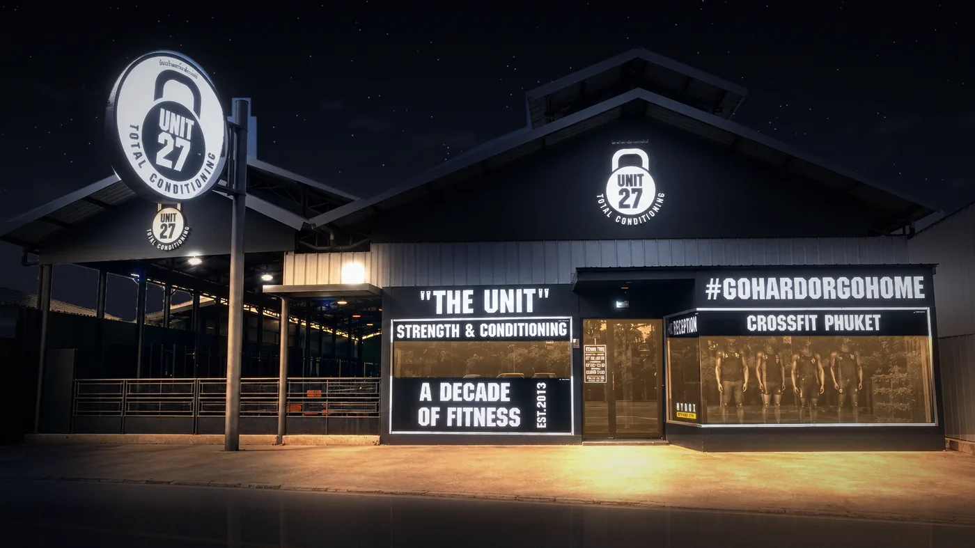 Unit 27 storefront on Soi Ta-iad at night, signs lit